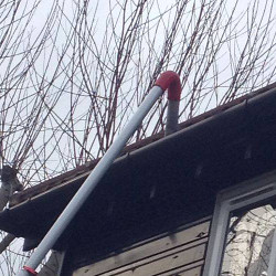 Gutters being cleaned from ground level